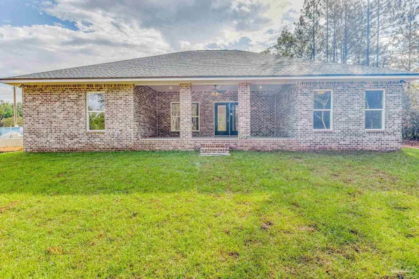 a front view of house with yard and green space