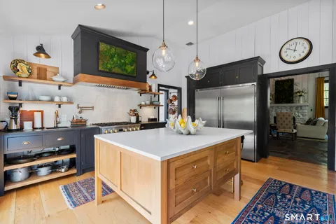 a kitchen with cabinets and wooden floor