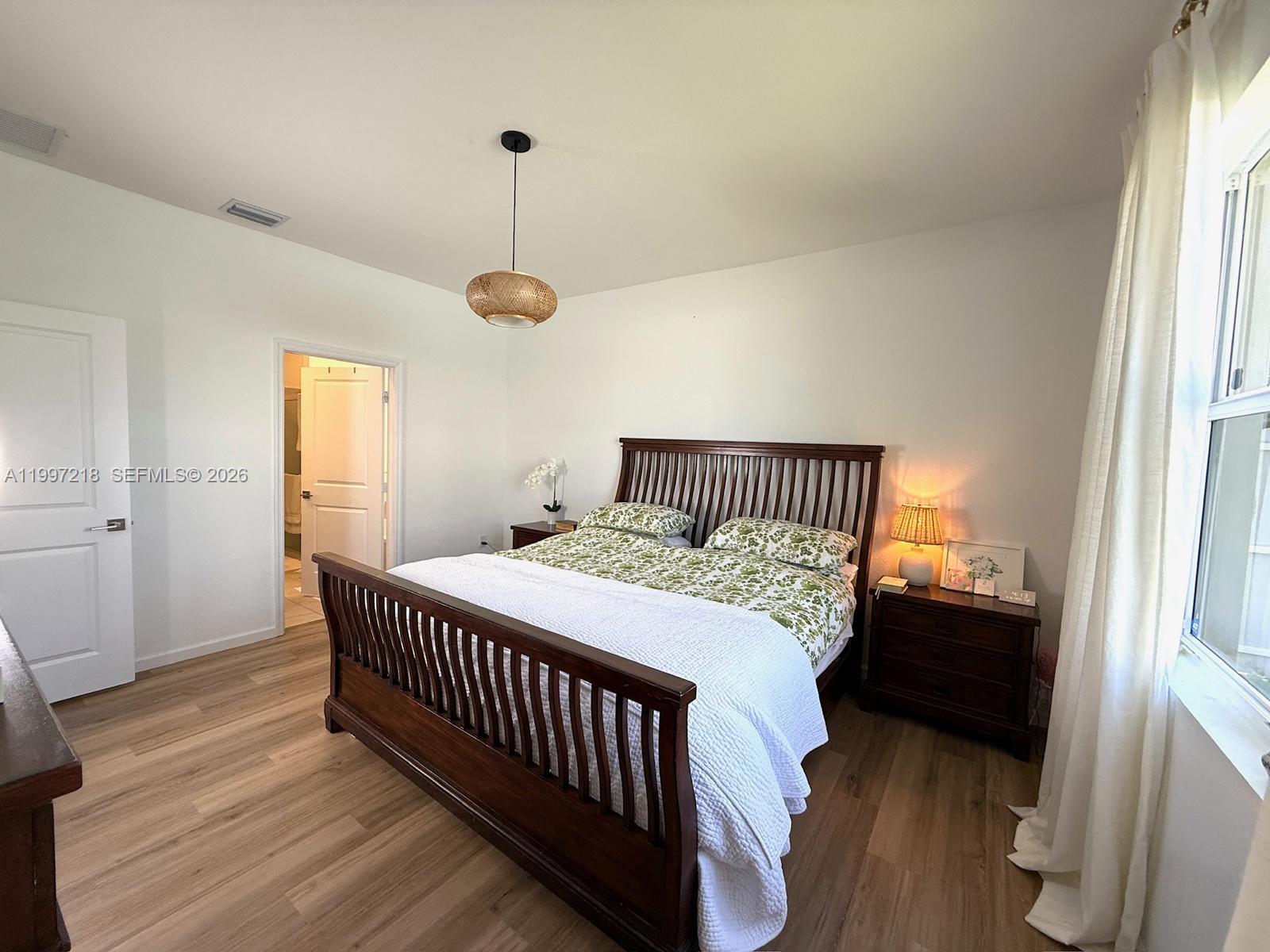 13233 Southwest 272nd Street Homestead, FL 33032 - Photo 13 of 21 a bedroom with a bed and wooden floor