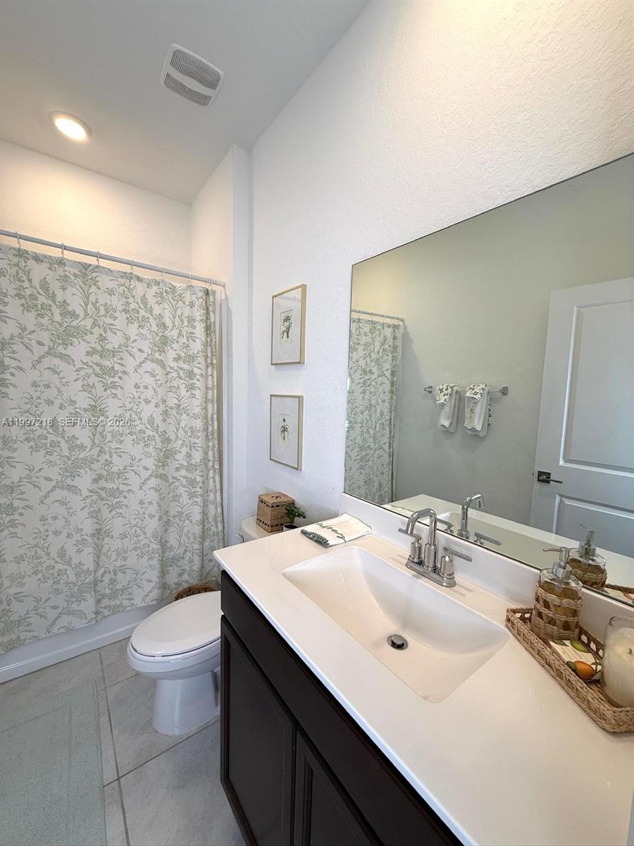 13233 Southwest 272nd Street Homestead, FL 33032 - Photo 16 of 21 a bathroom with a sink a toilet and shower