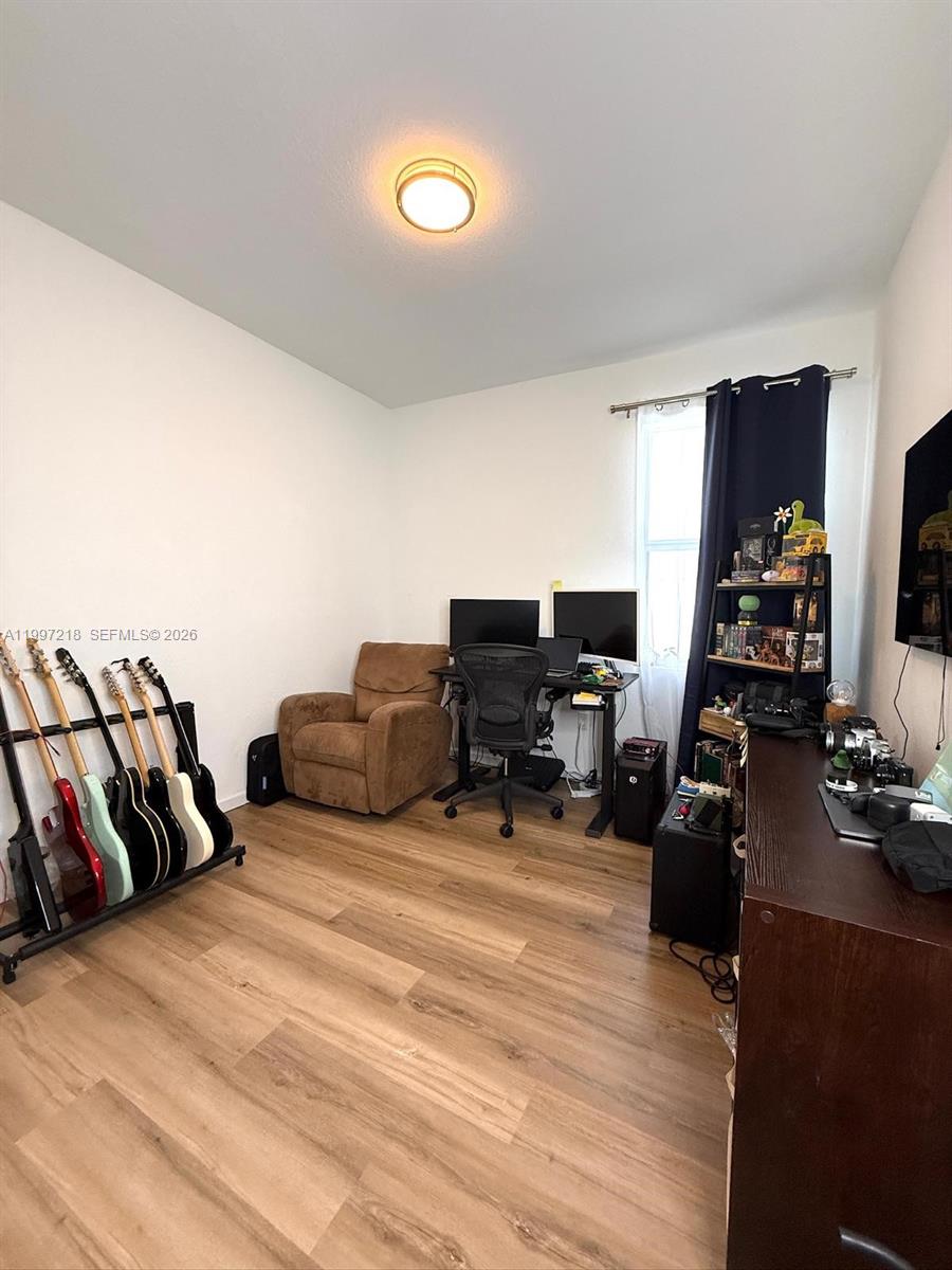 13233 Southwest 272nd Street Homestead, FL 33032 - Photo 19 of 21 a bedroom with furniture and a flat screen tv