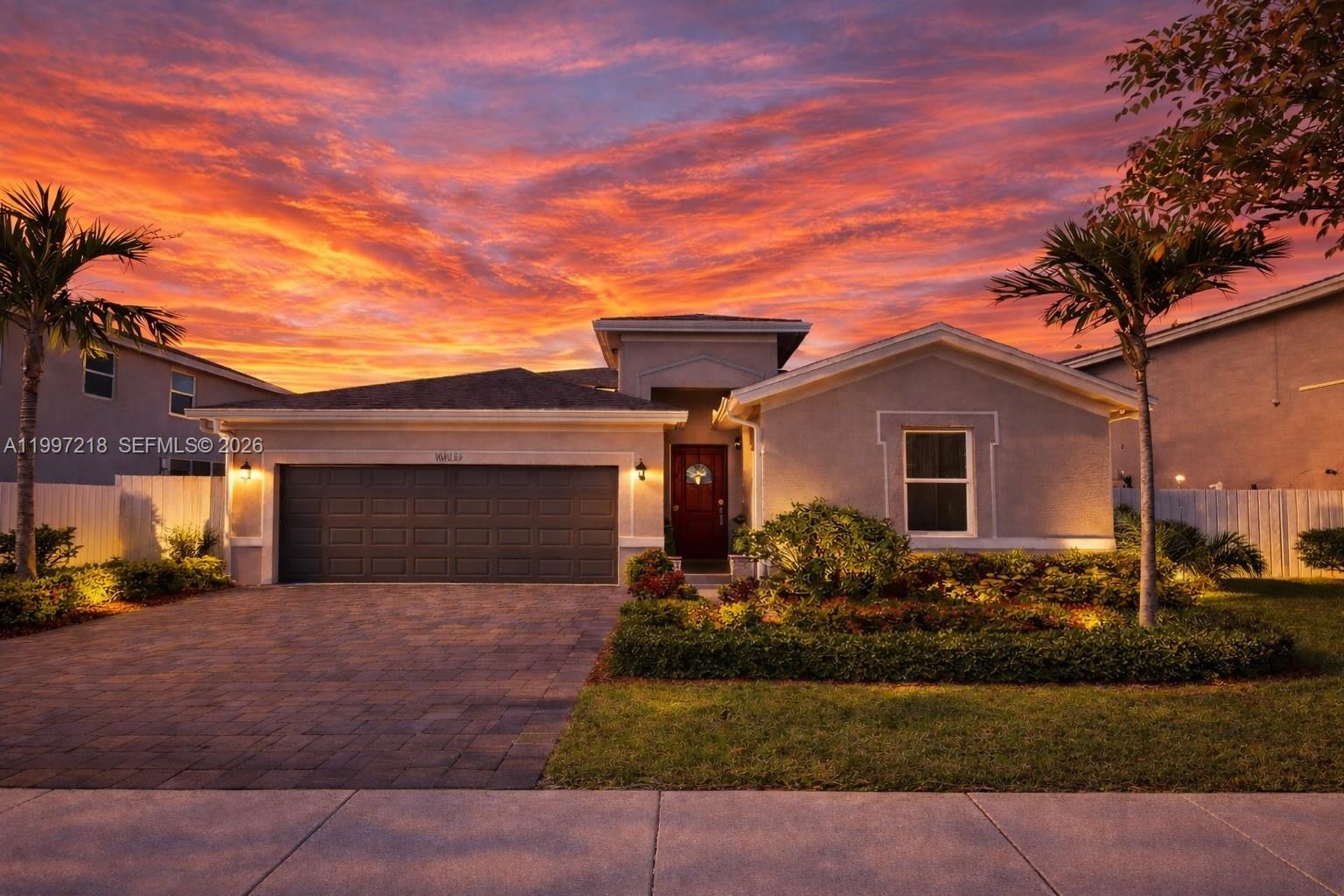 13233 Southwest 272nd Street Homestead, FL 33032 - Photo 2 of 21 a front view of a house with a yard and garage