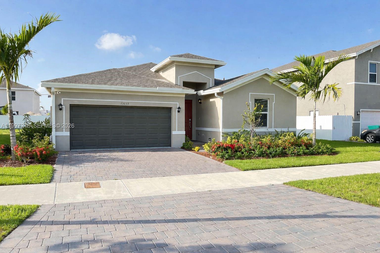 13233 Southwest 272nd Street Homestead, FL 33032 - Photo 21 of 21 a front view of a house with garden