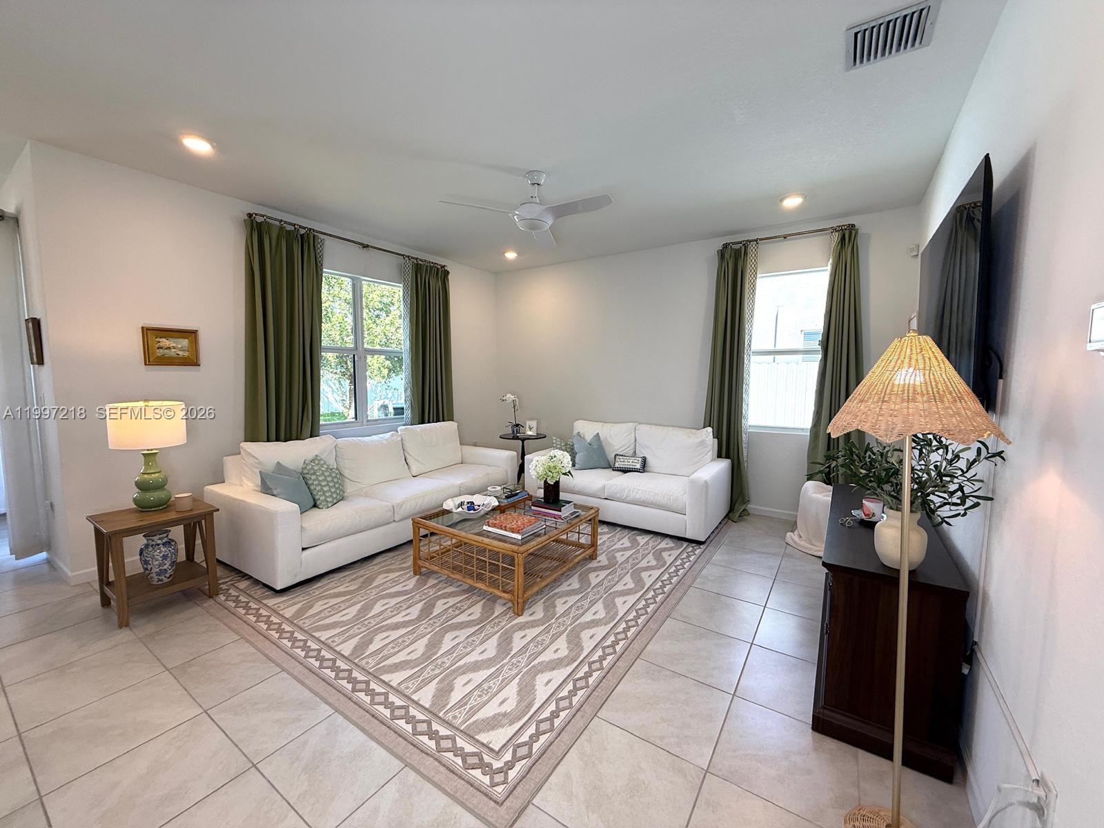 13233 Southwest 272nd Street Homestead, FL 33032 - Photo 4 of 21 a living room with furniture and a large window