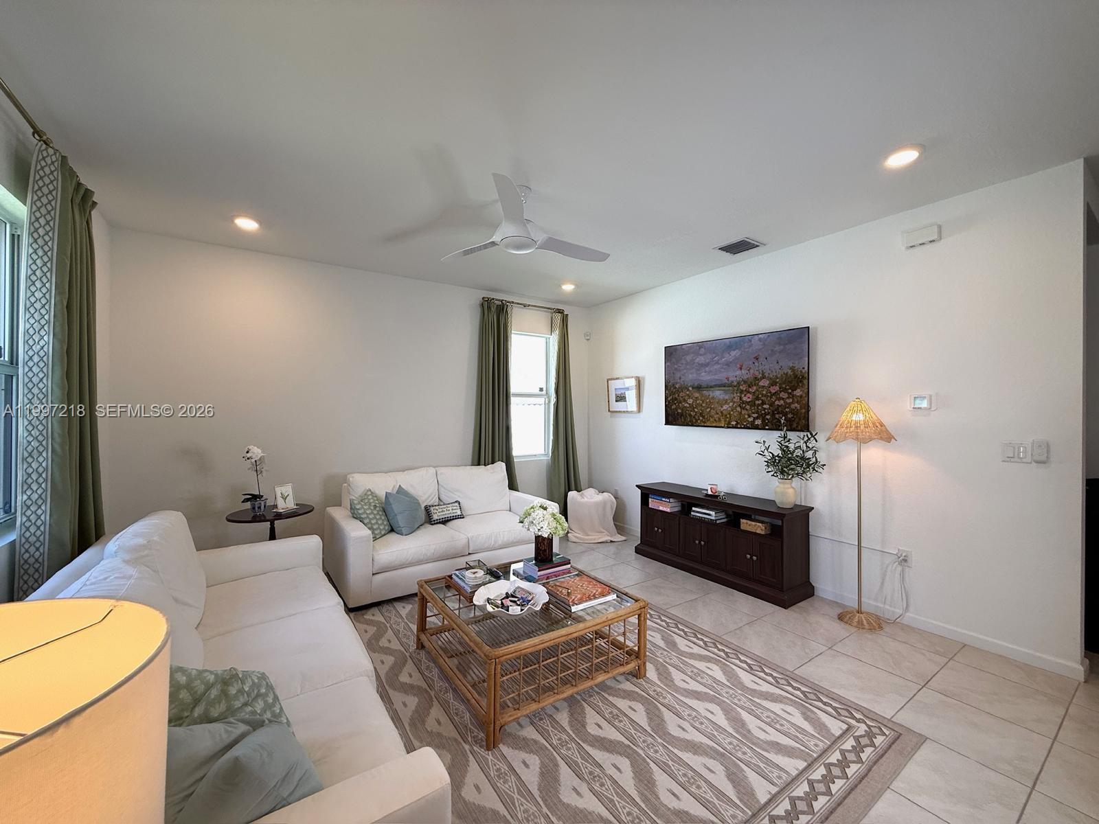 13233 Southwest 272nd Street Homestead, FL 33032 - Photo 5 of 21 a living room with furniture and a flat screen tv