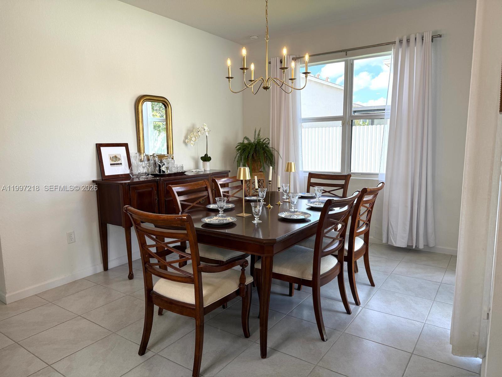 13233 Southwest 272nd Street Homestead, FL 33032 - Photo 7 of 21 a view of a dining room with furniture and a chandelier