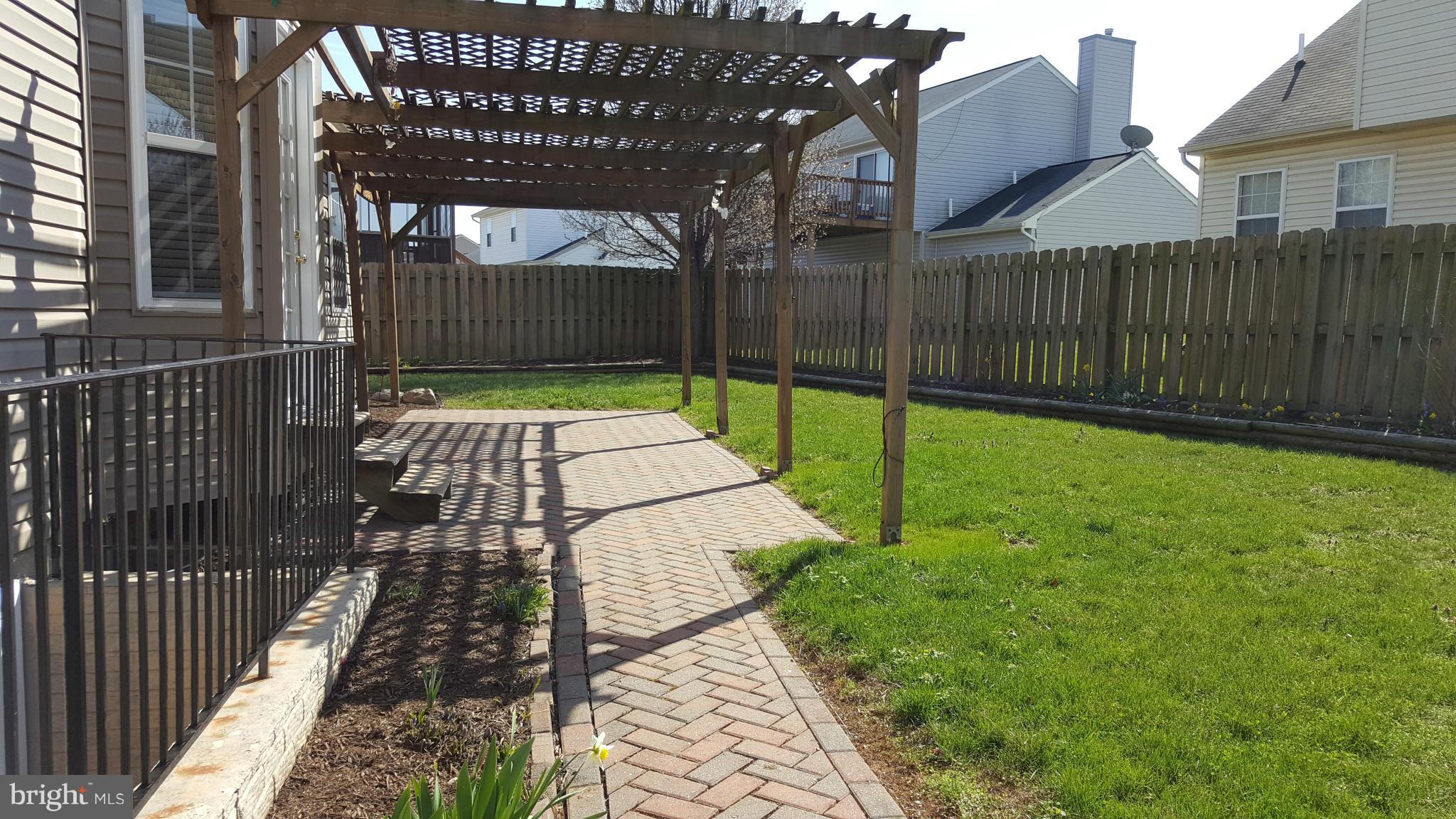 102 Limited Drive Ranson, WV 25438 - Photo 2 of 23 a view of a backyard with a wooden fence