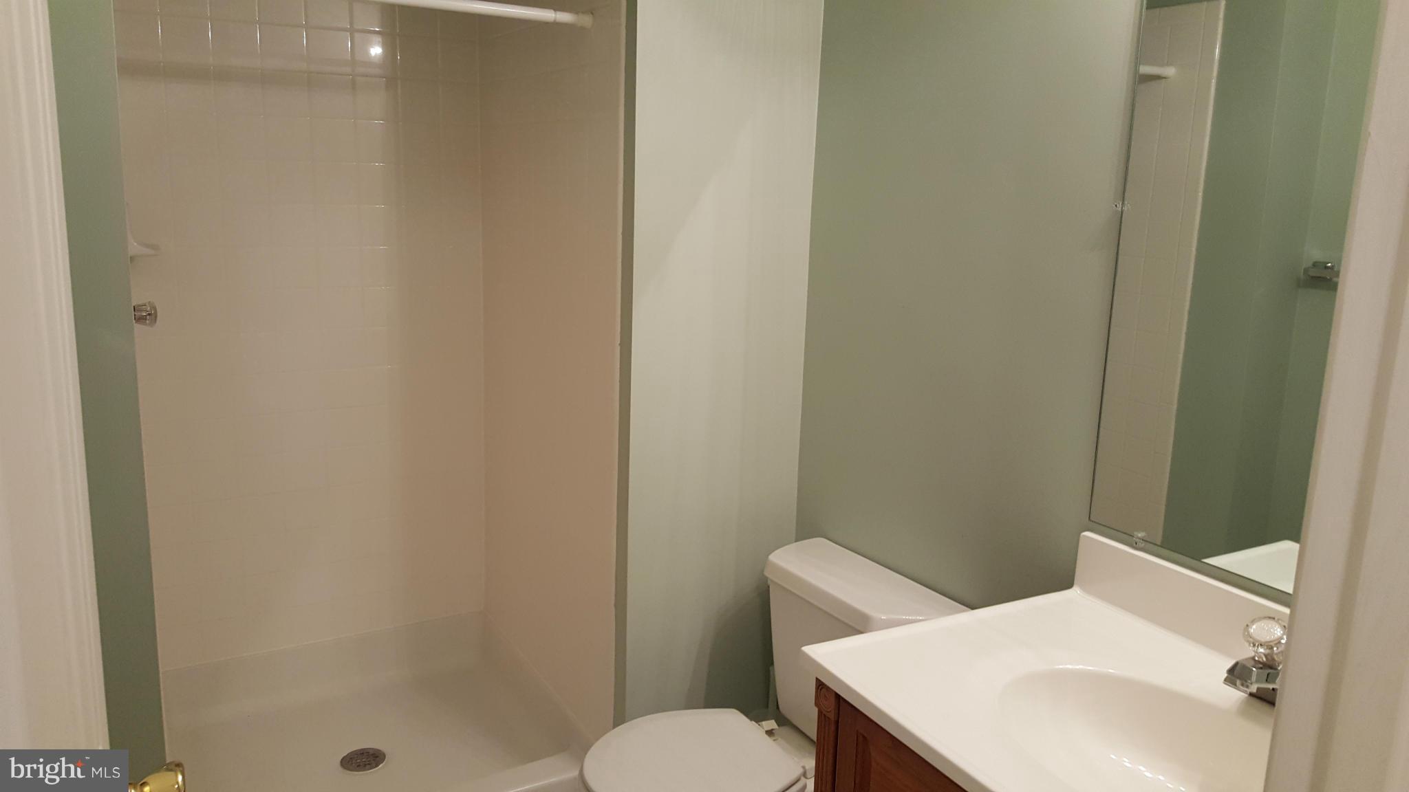 102 Limited Drive Ranson, WV 25438 - Photo 19 of 23 a bathroom with a sink and mirror