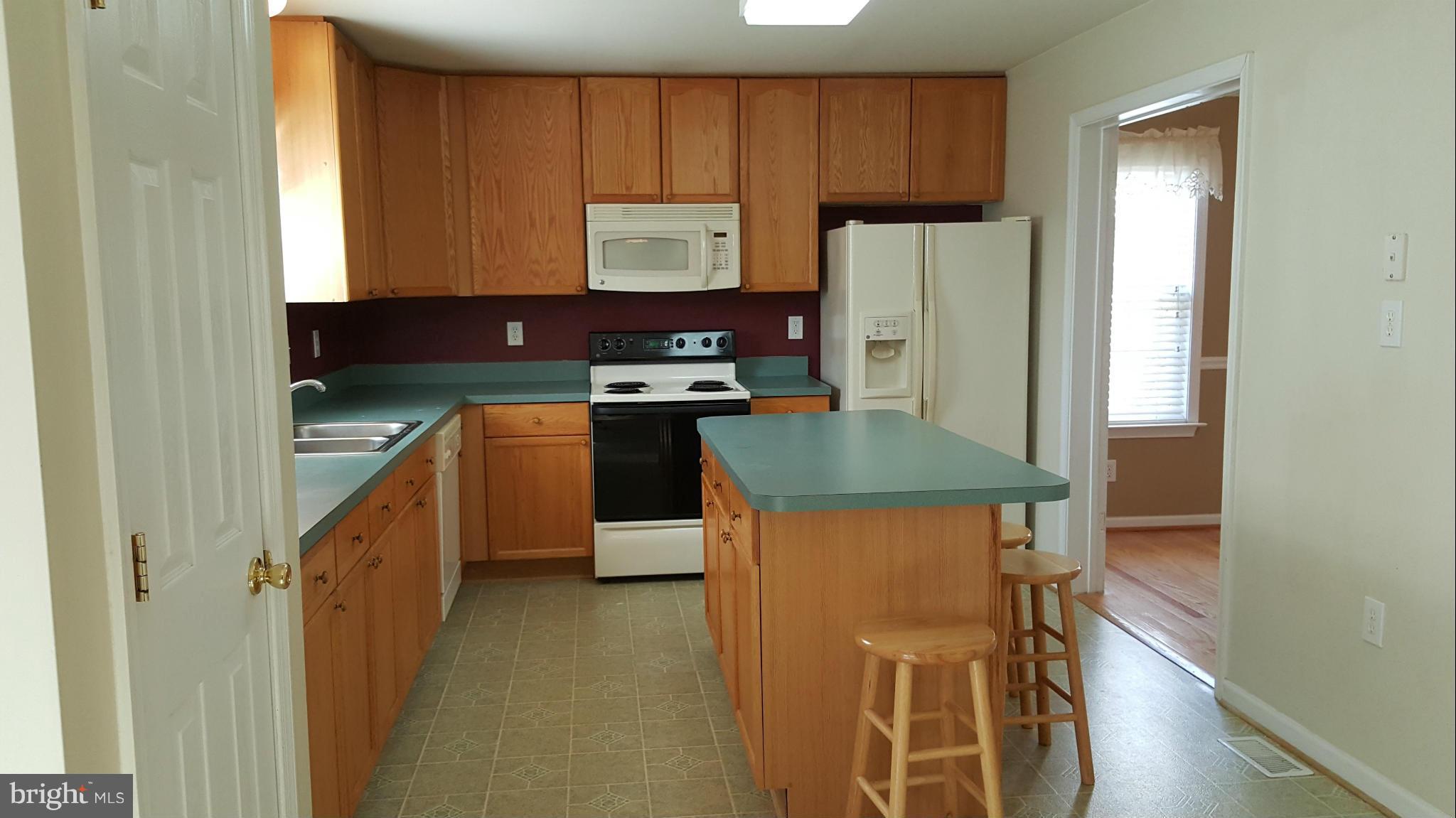 102 Limited Drive Ranson, WV 25438 - Photo 5 of 23 a kitchen with stainless steel appliances granite countertop a refrigerator a stove a sink and a microwave
