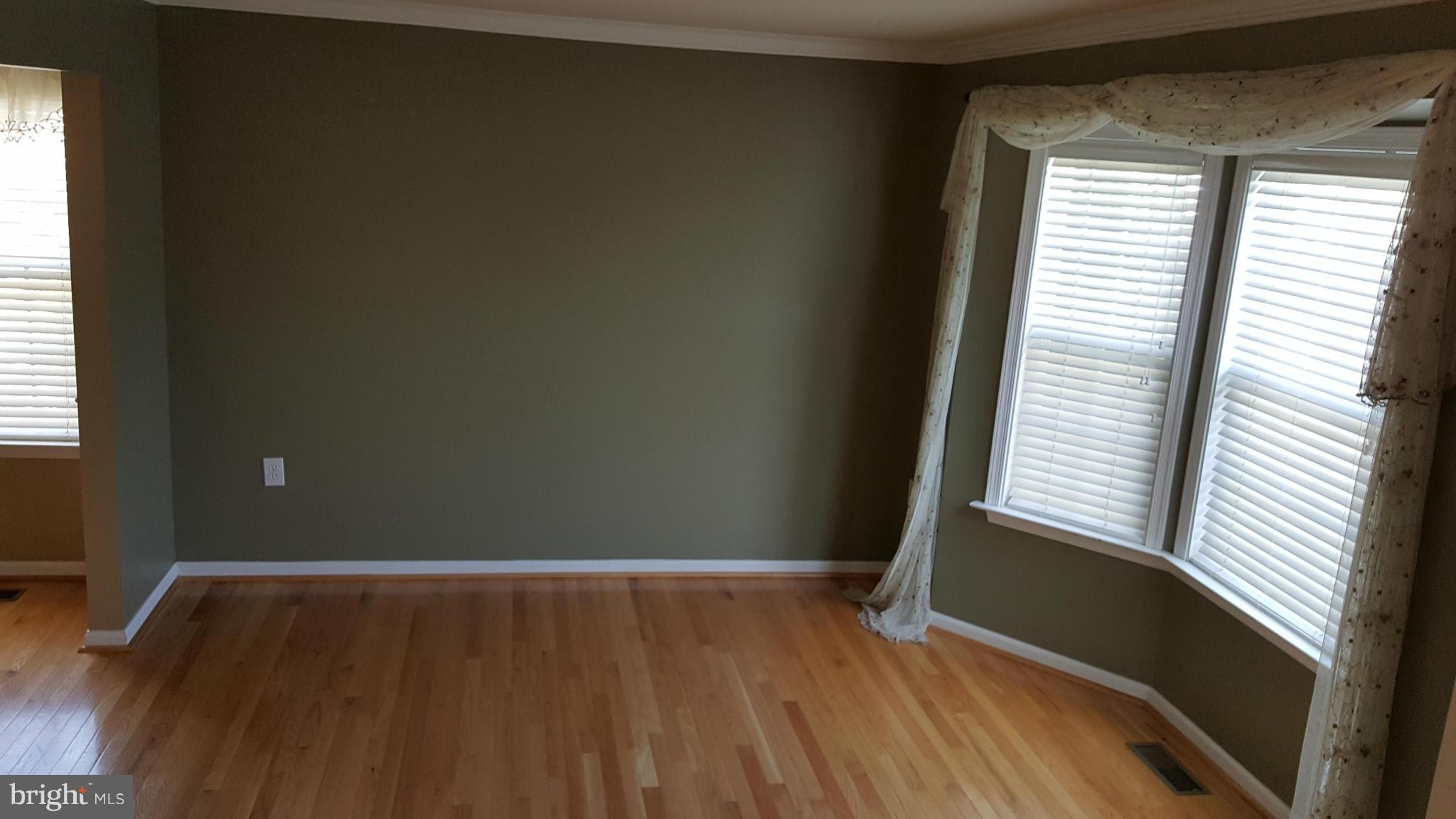 102 Limited Drive Ranson, WV 25438 - Photo 6 of 23 a view of an empty room with wooden floor and a window
