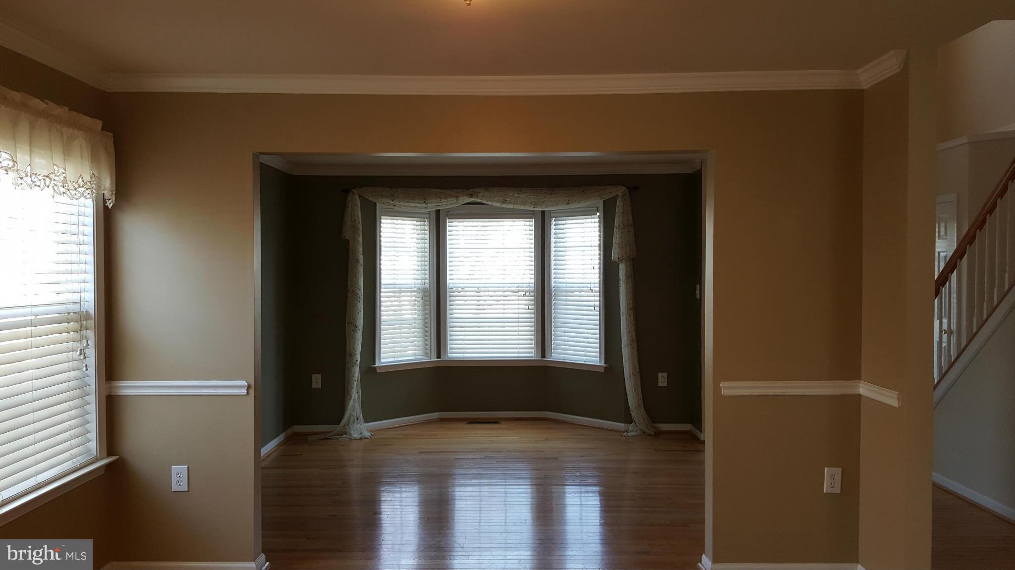 102 Limited Drive Ranson, WV 25438 - Photo 8 of 23 a view of empty room with wooden floor and fan