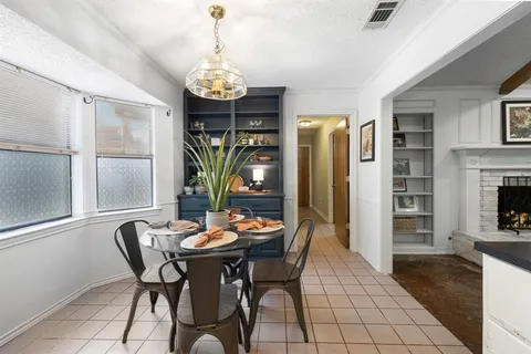 a view of a dining room with furniture and chandelier