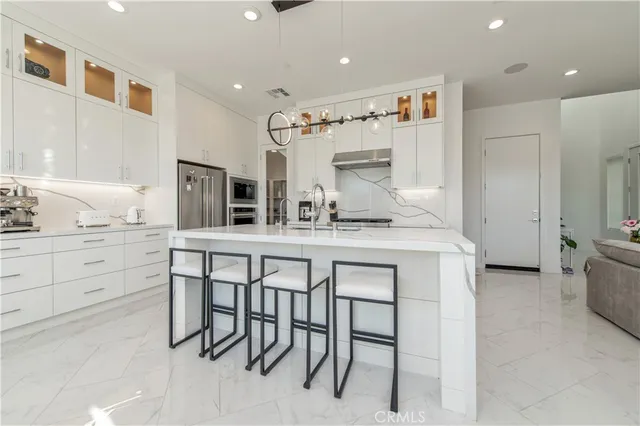 a kitchen with cabinets and chairs