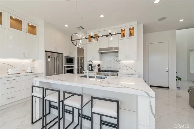a kitchen with kitchen island a table and chairs