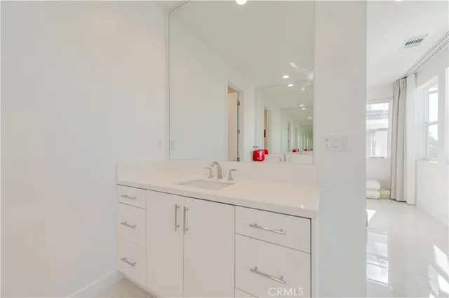a bathroom with a shower sink and mirror