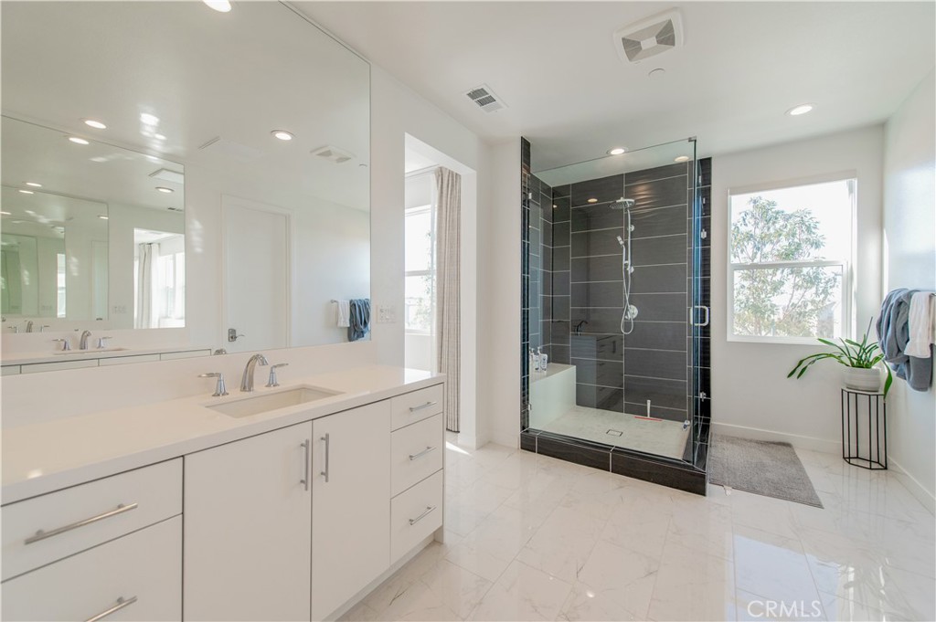 131 Reyes Alley Lake Forest, CA 92630 - Photo 28 of 39 a bathroom with a shower sink and mirror