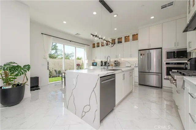 a kitchen with refrigerator cabinets and large window