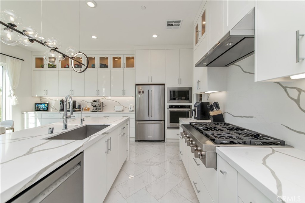 131 Reyes Alley Lake Forest, CA 92630 - Photo 10 of 39 a kitchen with stainless steel appliances a sink stove and refrigerator