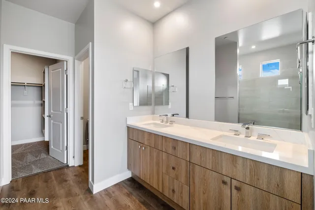 a bathroom with double vanity sinks and a mirror