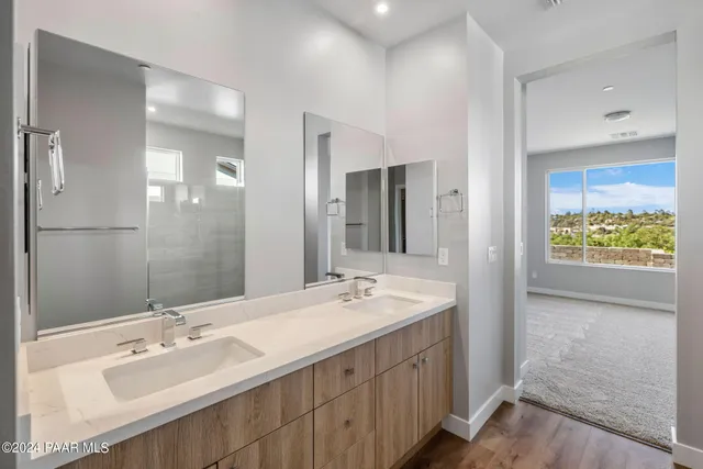 a bathroom with a double vanity sink and a mirror