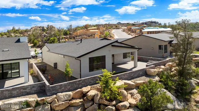 an aerial view of a house with a yard