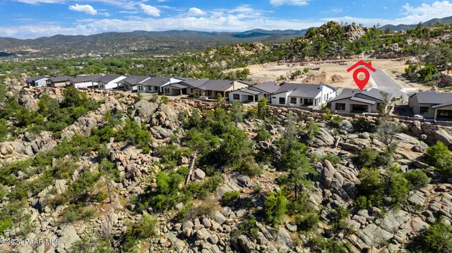 an aerial view of a house with a yard
