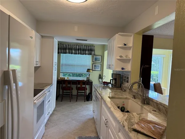 a bathroom with a double vanity sink a mirror and a bathtub