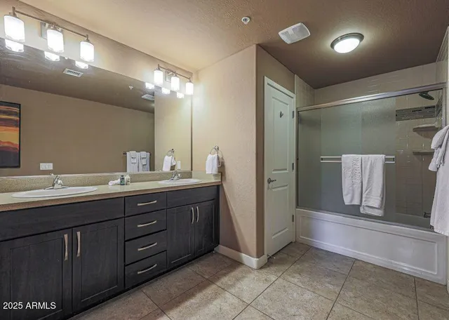 a bathroom with a double vanity sink and a mirror