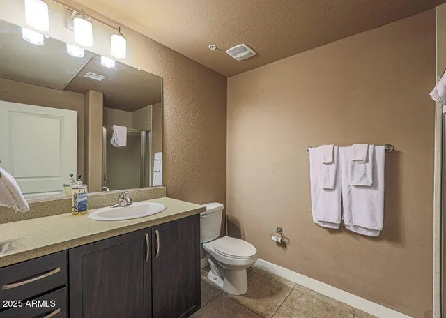 a bathroom with a sink a toilet and mirror