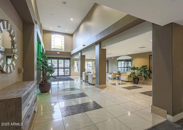 a lobby with furniture and floor to ceiling window