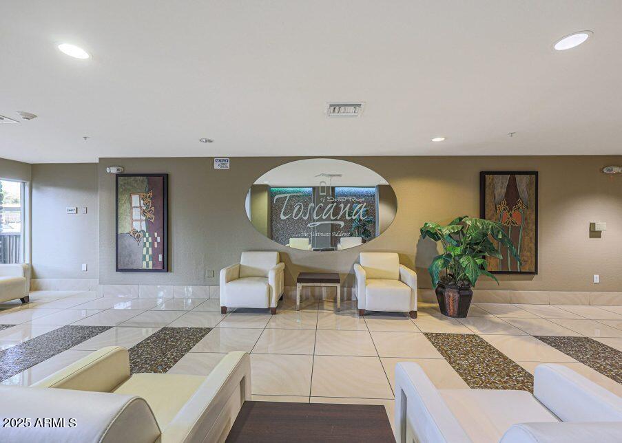 5450 East Deer Valley Drive, Unit 2191 Phoenix, AZ 85054 - Photo 21 of 50 a living room with furniture and a chandelier