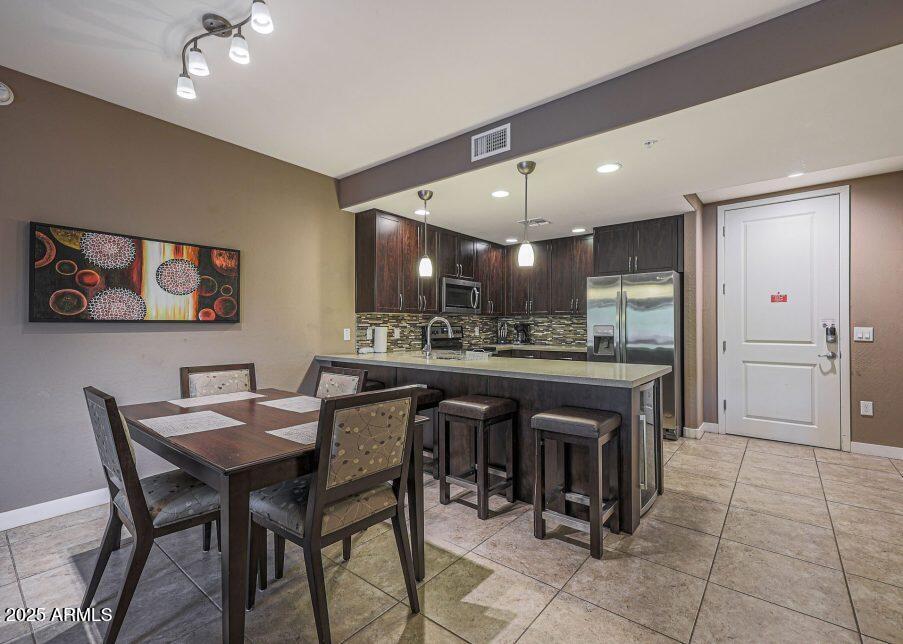 5450 East Deer Valley Drive, Unit 2191 Phoenix, AZ 85054 - Photo 4 of 50 a kitchen with a sink and chairs