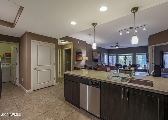 a kitchen with stainless steel appliances granite countertop a sink a counter space and cabinets