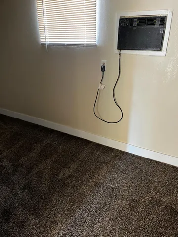 a picture of a room with wooden floor and a window