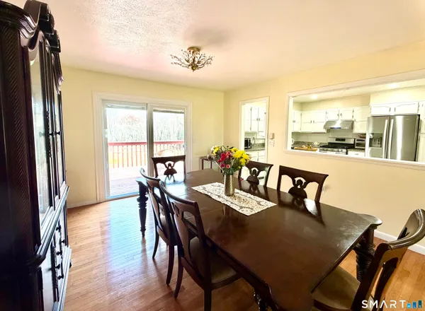 a view of a dining room with furniture and a window