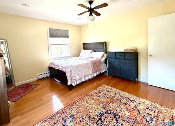 a bedroom with a bed and a dresser