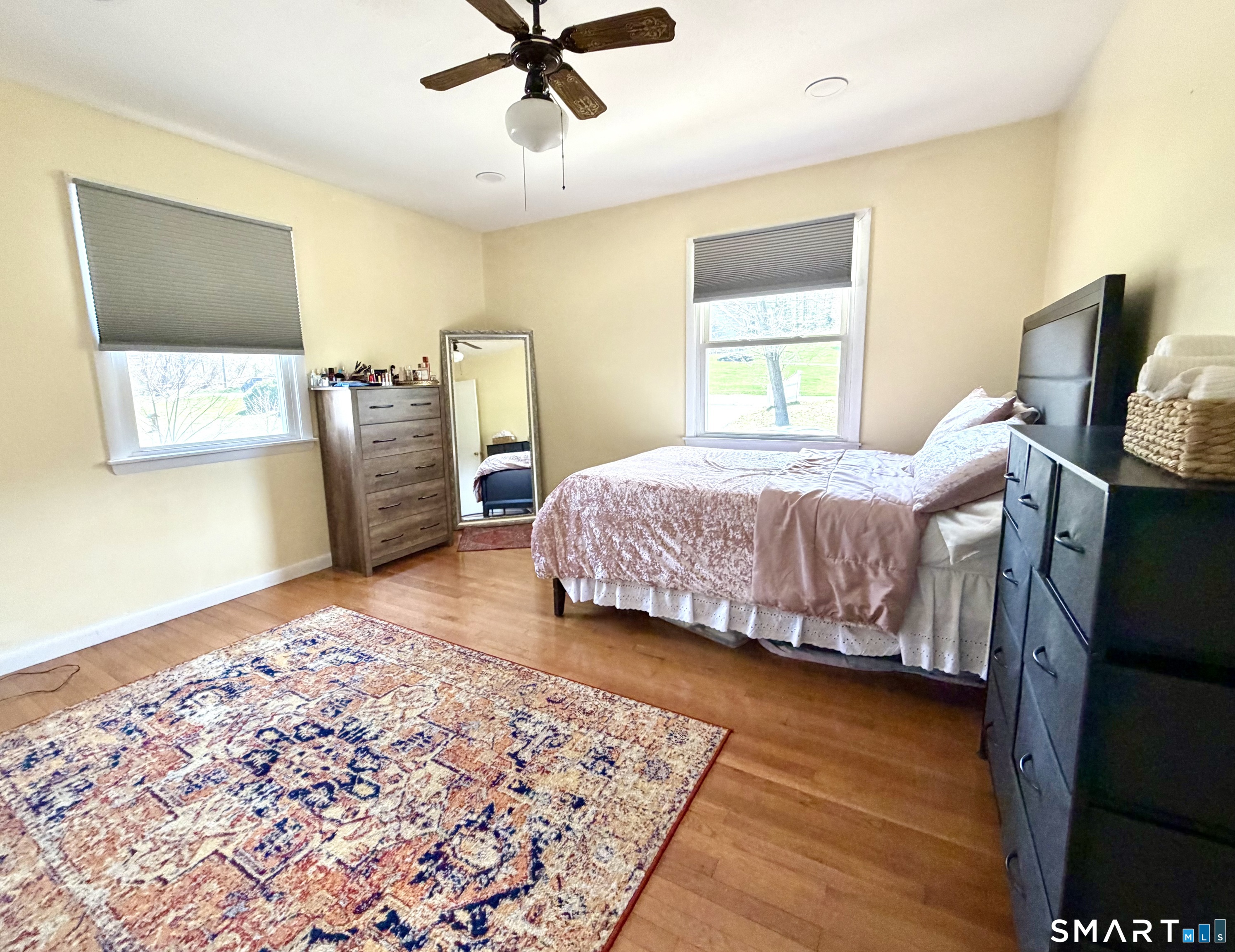 277 Windsorville Road Ellington, CT 06029 - Photo 22 of 40 a bedroom with a bed and wooden floor
