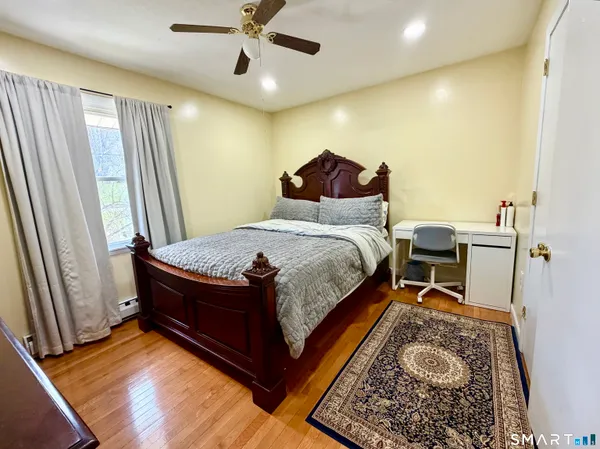 a bed room with a bed and a chair