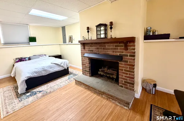 a living room with a bed furniture and a fireplace