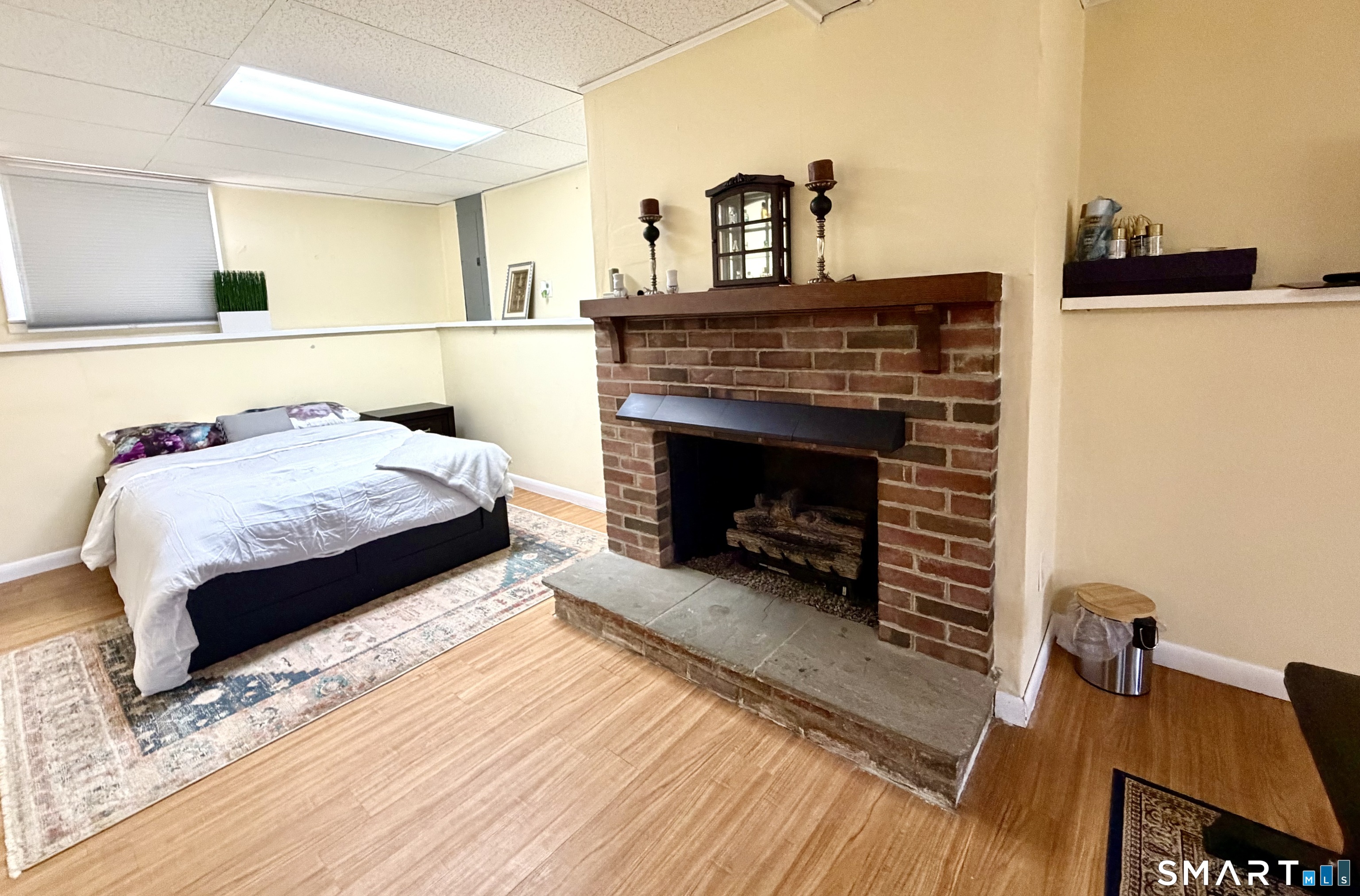 277 Windsorville Road Ellington, CT 06029 - Photo 28 of 40 a living room with a bed furniture and a fireplace