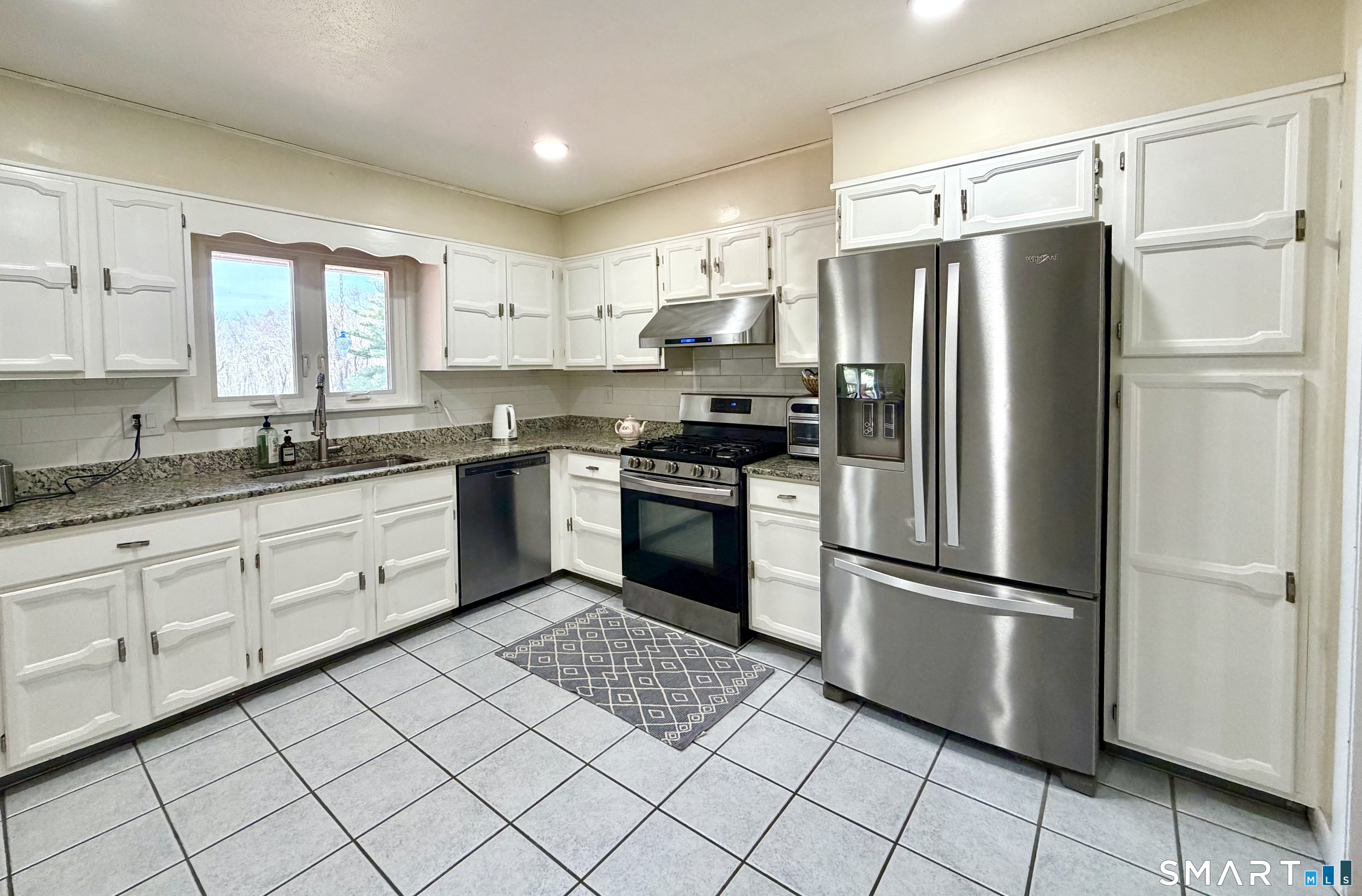 277 Windsorville Road Ellington, CT 06029 - Photo 4 of 40 a kitchen with a refrigerator a sink and cabinets