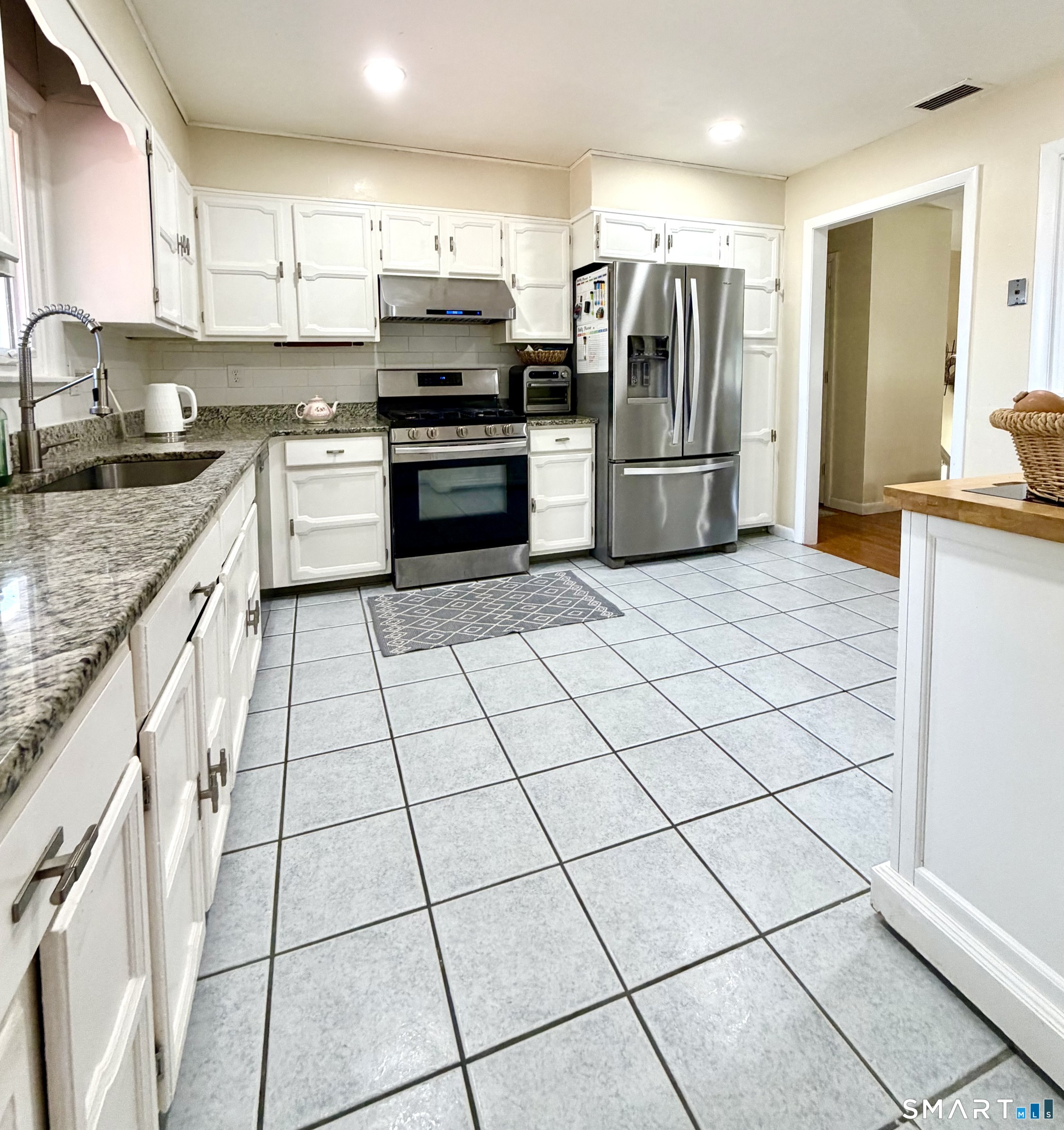 277 Windsorville Road Ellington, CT 06029 - Photo 5 of 40 a kitchen with stainless steel appliances granite countertop a refrigerator and a stove top oven