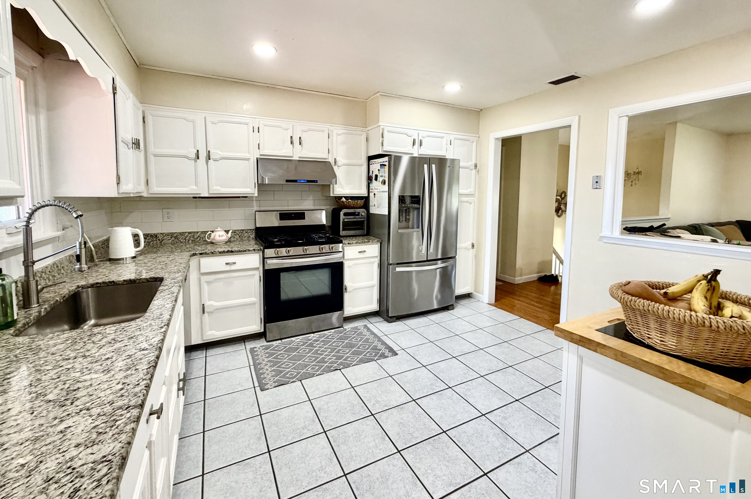277 Windsorville Road Ellington, CT 06029 - Photo 6 of 40 a kitchen with stainless steel appliances granite countertop a stove a sink and a refrigerator