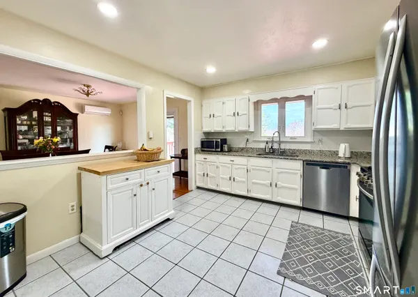 a kitchen with a sink cabinets and window