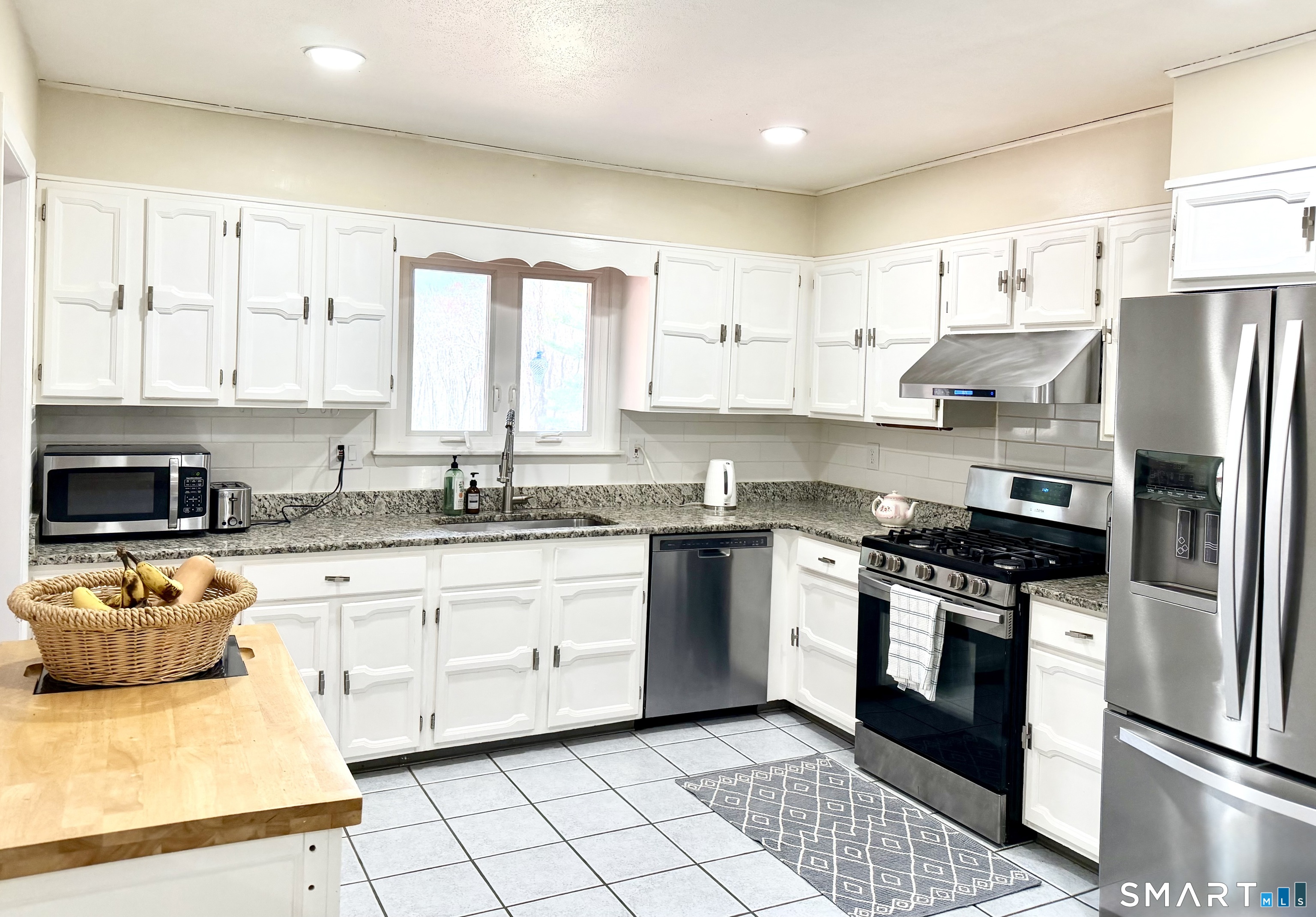 277 Windsorville Road Ellington, CT 06029 - Photo 10 of 40 a kitchen with stainless steel appliances granite countertop a stove a sink and a refrigerator