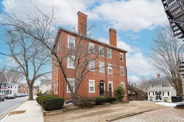 a front view of a building with trees
