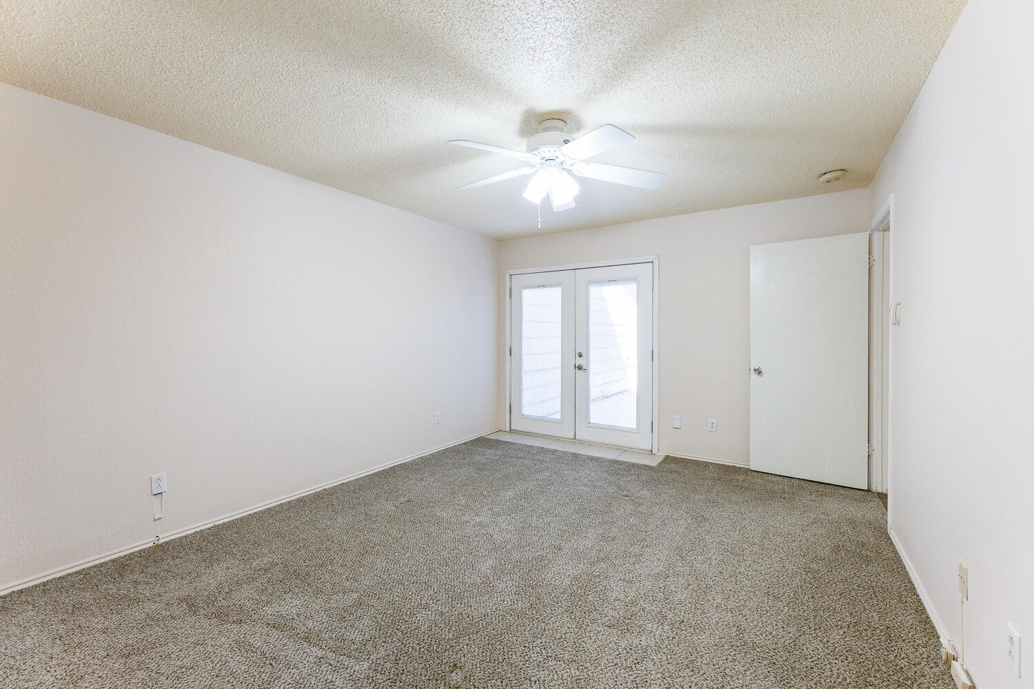 3316 79th Street Lubbock, TX 79423 - Photo 23 of 45 an empty room with chandelier fan and windows