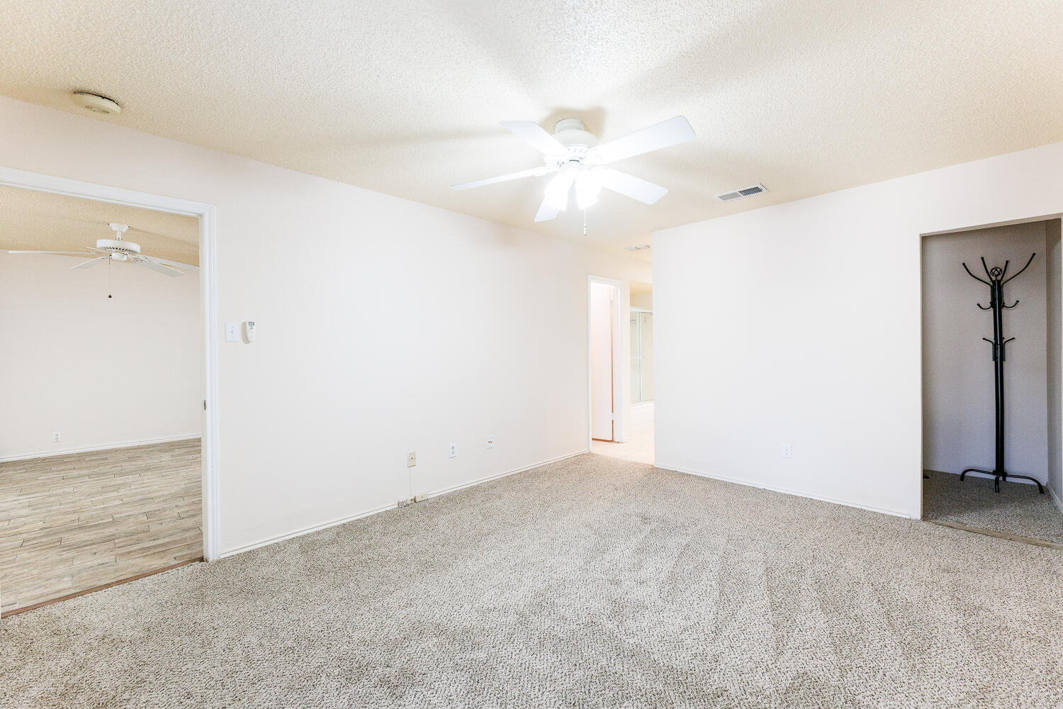 3316 79th Street Lubbock, TX 79423 - Photo 25 of 45 an empty room with closet and a chandelier fan