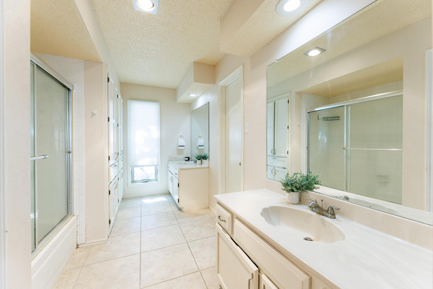 3316 79th Street Lubbock, TX 79423 - Photo 26 of 45 a bathroom with a bathtub shower sink and mirror
