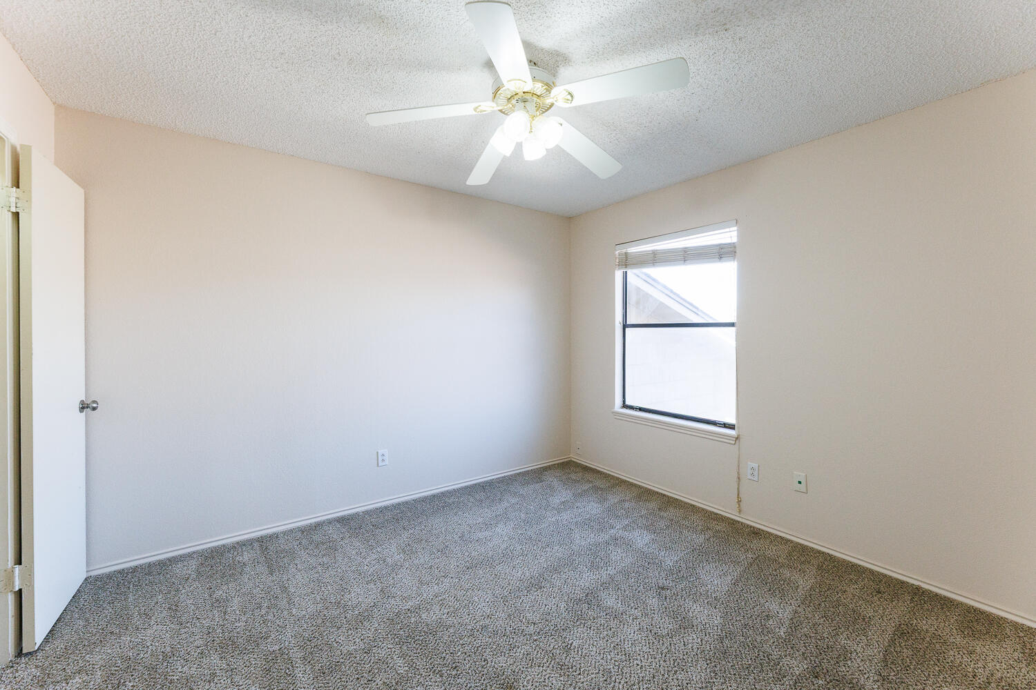3316 79th Street Lubbock, TX 79423 - Photo 31 of 45 an empty room with windows and fan